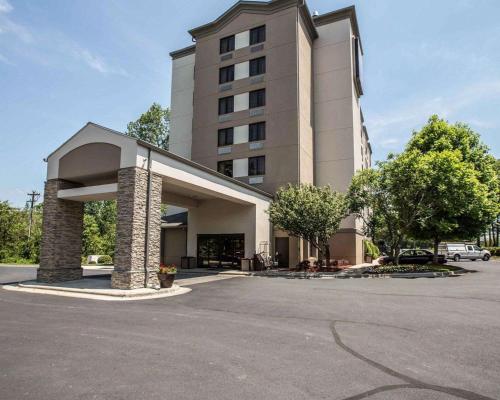 a building with a parking lot in front of it at Sleep Inn Greensboro Airport in Greensboro