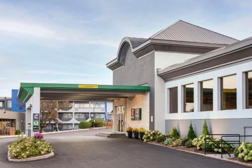 a gas station in front of a building at Comfort Suites Kingston Central in Kingston