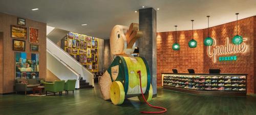 a store with a surfboard in the middle of a room at Graduate by Hilton Eugene in Eugene