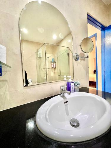 a bathroom with a sink and a mirror at Comfort Home Patong in Patong Beach