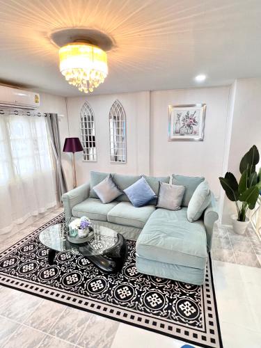 a living room with a couch and a table at Comfort Home Patong in Patong Beach