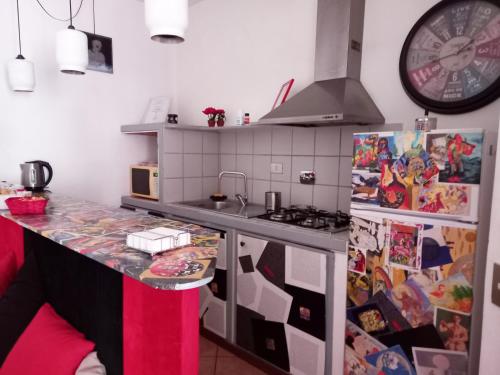 a kitchen with a counter top and a refrigerator at Rosso rubino in Rome