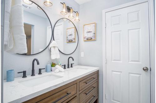 a bathroom with a sink and a mirror at Comfortable 4BR2.5BA Family Home Near Riverwalk in San Antonio