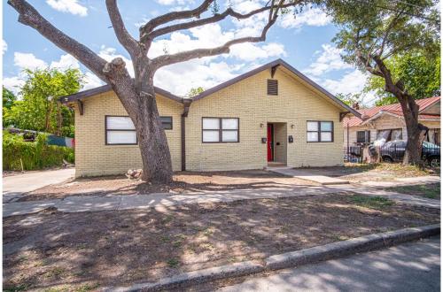 a house with a tree in front of it at Modern Living 3BR2BA Close to Amazing Downtown in San Antonio