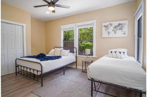 two beds in a room with a window at Modern Living 3BR2BA Close to Amazing Downtown in San Antonio