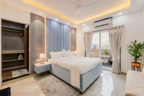 a bedroom with a large bed and a television at Kyomi Service Apartments in Gurgaon