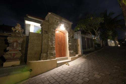 a building with an orange door at night at Winaka Ubud in Ubud