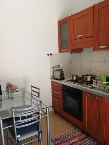 a kitchen with a table and a stove top oven at House Alexia in Petrás