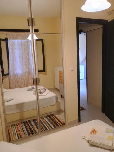 a mirror in a room with a bed and a bedroom at House Alexia in Petrás