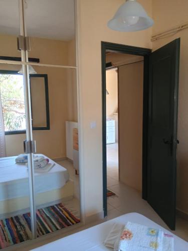 a mirror in a room with a bed and a bedroom at House Alexia in Petrás