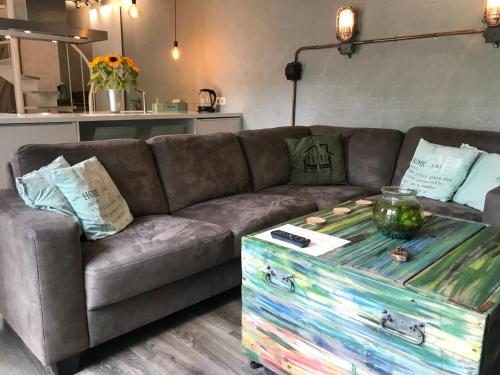 a living room with a couch and a table with a trunk at Villa Pats in Gilze
