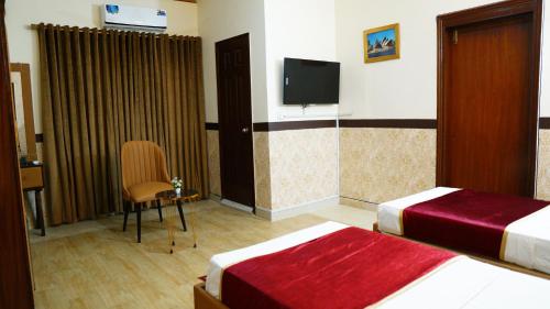 Postel nebo postele na pokoji v ubytování Orchid Inn by WI Hotel