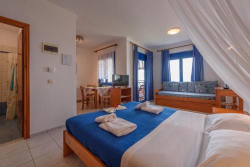 a bedroom with a large bed with towels on it at Finikas Studios & Apartments - Kalamaki Holidays in Kalamaki