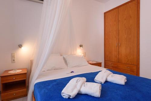 a bedroom with a bed with two towels on it at Finikas Studios & Apartments - Kalamaki Holidays in Kalamaki