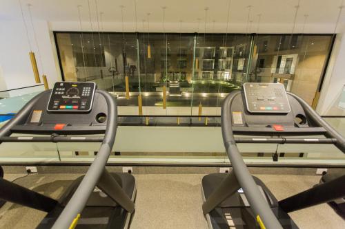 a gym with two treadmills in front of a window at Accra Luxury Apartments at Embassy Gardens in Accra