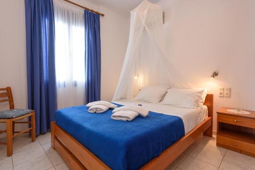 a bedroom with a bed with towels on it at Finikas Studios & Apartments - Kalamaki Holidays in Kalamaki