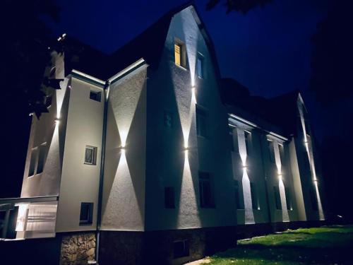a building with lights on it at night at 1923 Wohnung by Gerda in Etgersleben