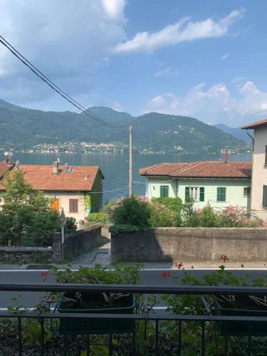 a view of a city with houses and a body of water at In center Cà del Pescatore lake view in Lierna