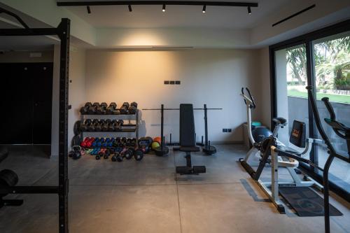 a gym with a lot of equipment in a room at Ollen apartments in Catania