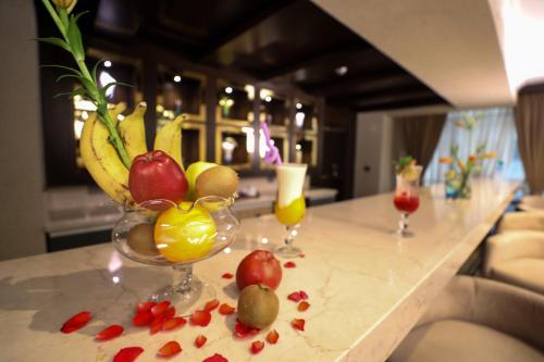 a counter with two glasses of fruit on a table at Cairo Taj Hotels & Suites- Mohandessin in Cairo