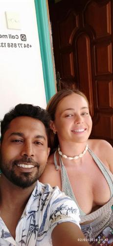 a man and a woman posing for a picture at Evoke Hostels, Hiriketiya beach in Dickwella