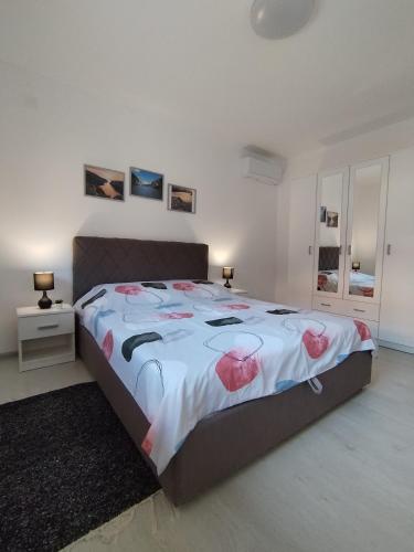 Un dormitorio con una cama grande con flores rosas. en Apartman Misic, en Donji Milanovac