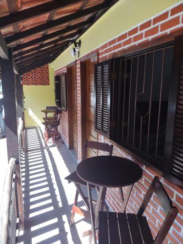 a patio with tables and chairs on a building at Cantinho do Vale Pousada in Penedo