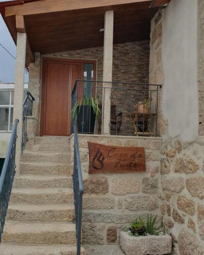 a house with a sign on the front of it at Casa da Fonte in Castro Daire