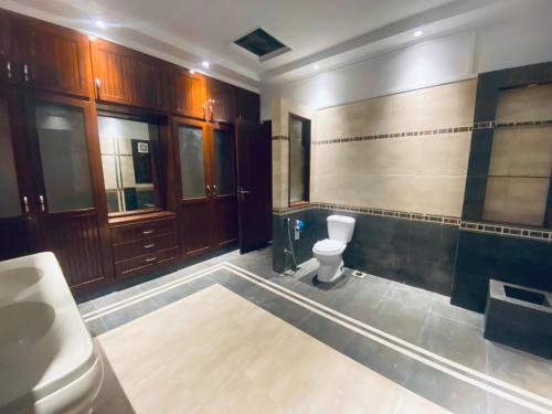 a bathroom with a toilet and a sink at Sunset BnB Creek in Karachi