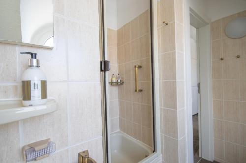 a shower with a glass door in a bathroom at Strandschönheit in Wangerooge