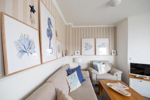 a living room with a couch and a table at Strandschönheit in Wangerooge