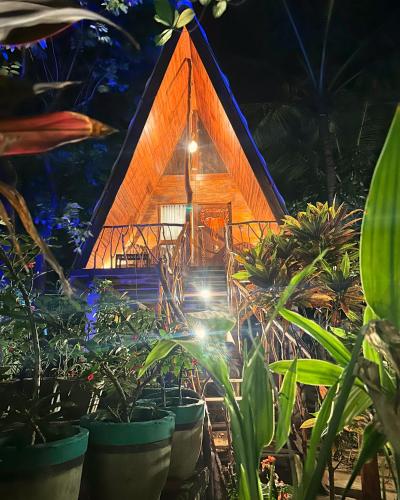 a tree house with plants in front of it at Levona Garden Resort in Habarana
