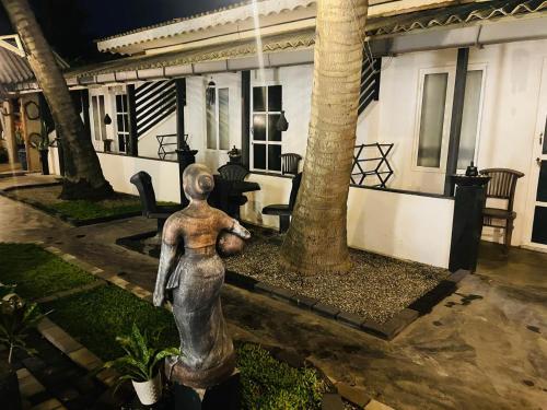 a statue of a woman standing in front of a house at Winston Sea Front Villa in Negombo