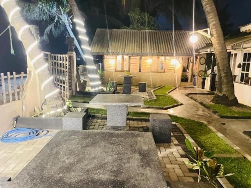 a patio with a bench and a house at night at Winston Sea Front Villa in Negombo