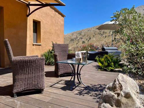a patio with a table and chairs and an umbrella at Baglio La Porta by Geocharme in San Vito lo Capo