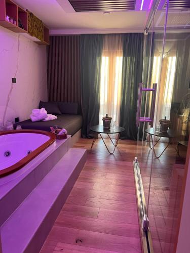 a bathroom with a large tub in the middle of a room at Love Me Nemi in Nemi