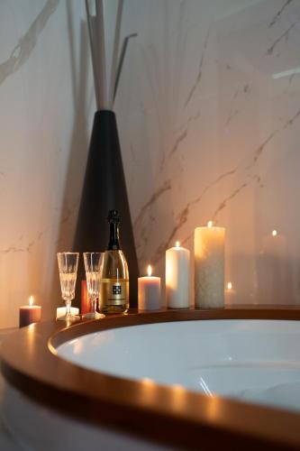 a bathroom with candles and a bottle of wine and two glasses at Love Me Nemi in Nemi