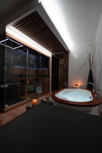 a large bathroom with a large tub and a large window at Love Me Nemi in Nemi