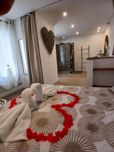two stuffed animals sitting on a bed in a room at Maison cosy entre mer et garrigue in Pomérols
