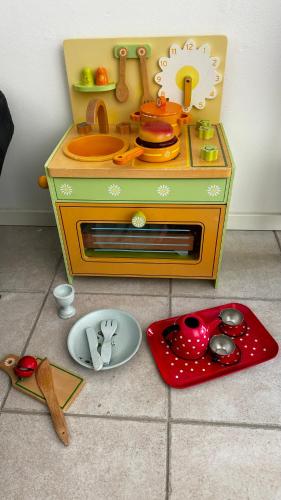 a toy kitchen with a stove and a plate on the floor at ꕥ Oceanfront Modern Apartment ꕥ in Helsinki