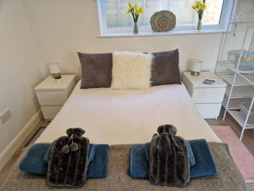 a bedroom with a bed with two towels on it at Ty Cwtch in Nottage