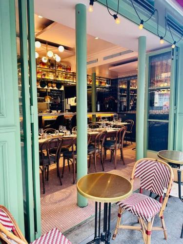 une salle à manger avec des tables et des chaises dans un restaurant dans l'établissement Appt rénové proche Montmartre Gare du Nord et EST, à Paris