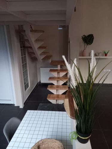 a spiral staircase in a room with a table at uRban Loft Living in Kardítsa