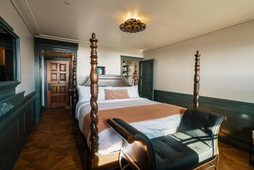 a bedroom with a bed and a chair at El Caminante Bar & Bungalows in Dana Point