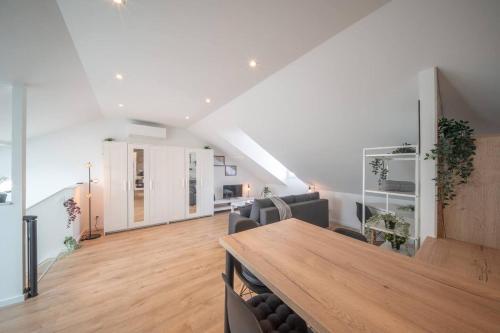 un salon avec une table et des chaises en bois dans l'établissement Superbe appartement climatisé parking free, à Mulhouse