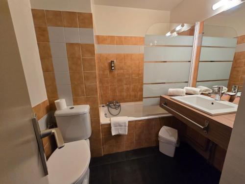 a bathroom with a toilet and a sink at Logis Hôtels Le Saint Marc in Mollans-sur-Ouvèze