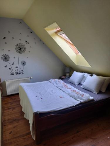 a bedroom with a large bed with a skylight at Jaun-Ieviņas in Rauna