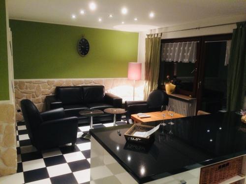 a living room with a couch and a table at Weingut Schumacher - mit privatem Saunabereich in Sankt Aldegund
