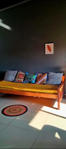 a wooden bed with pillows on it in a room at Altocostanera in Posadas