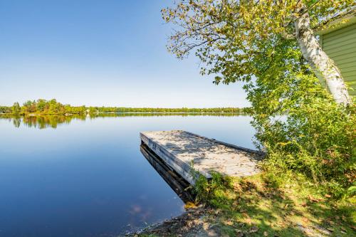 a dock sitting on the side of a lake at L'Étoile du Nord in Beaumont